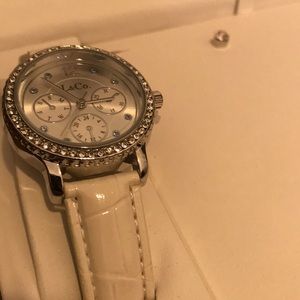 Silver watch with white band. Earrings
